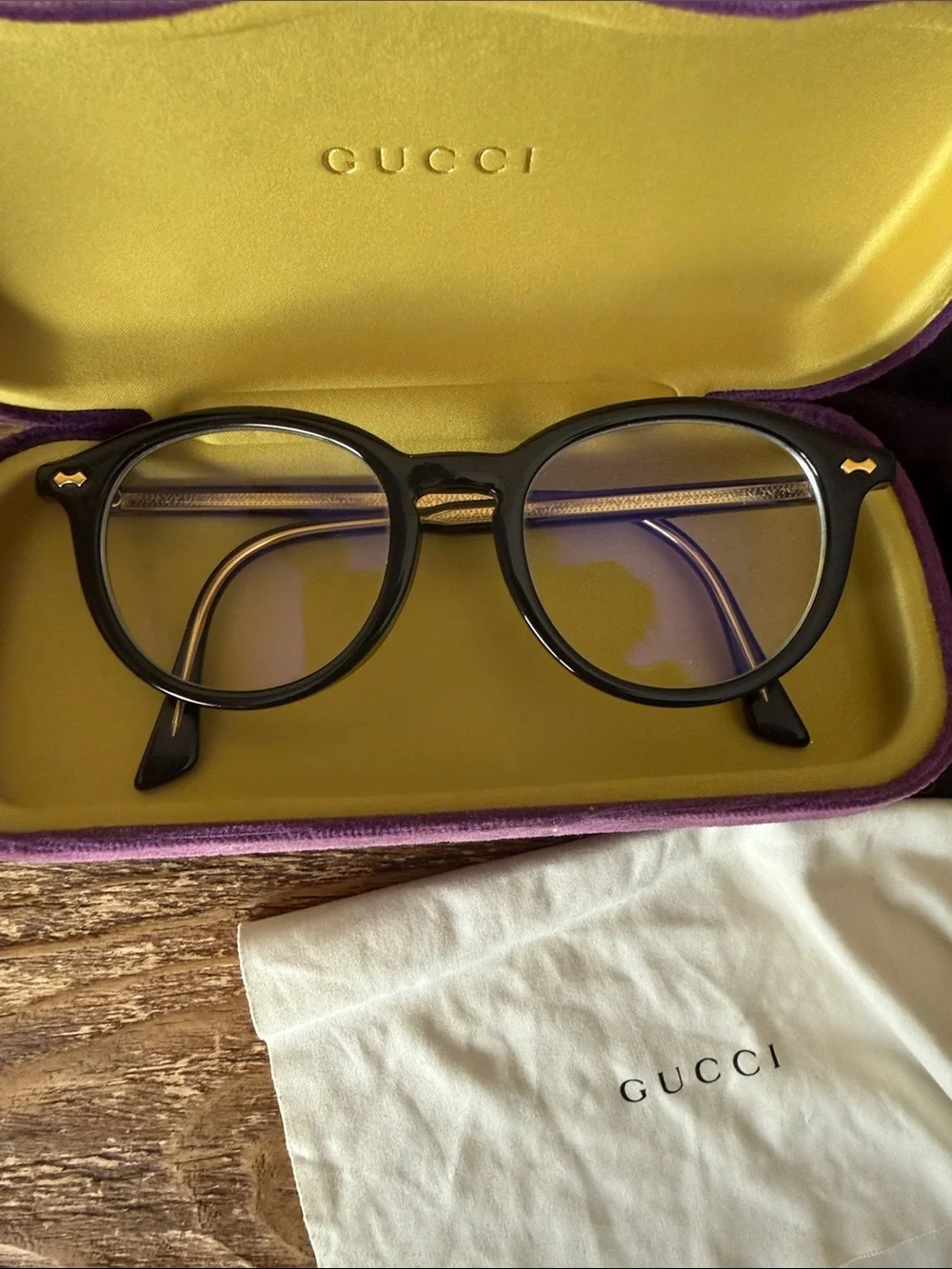 Gucci Black Round Optical Glasses with purple case, dust bag, and cleaning cloth